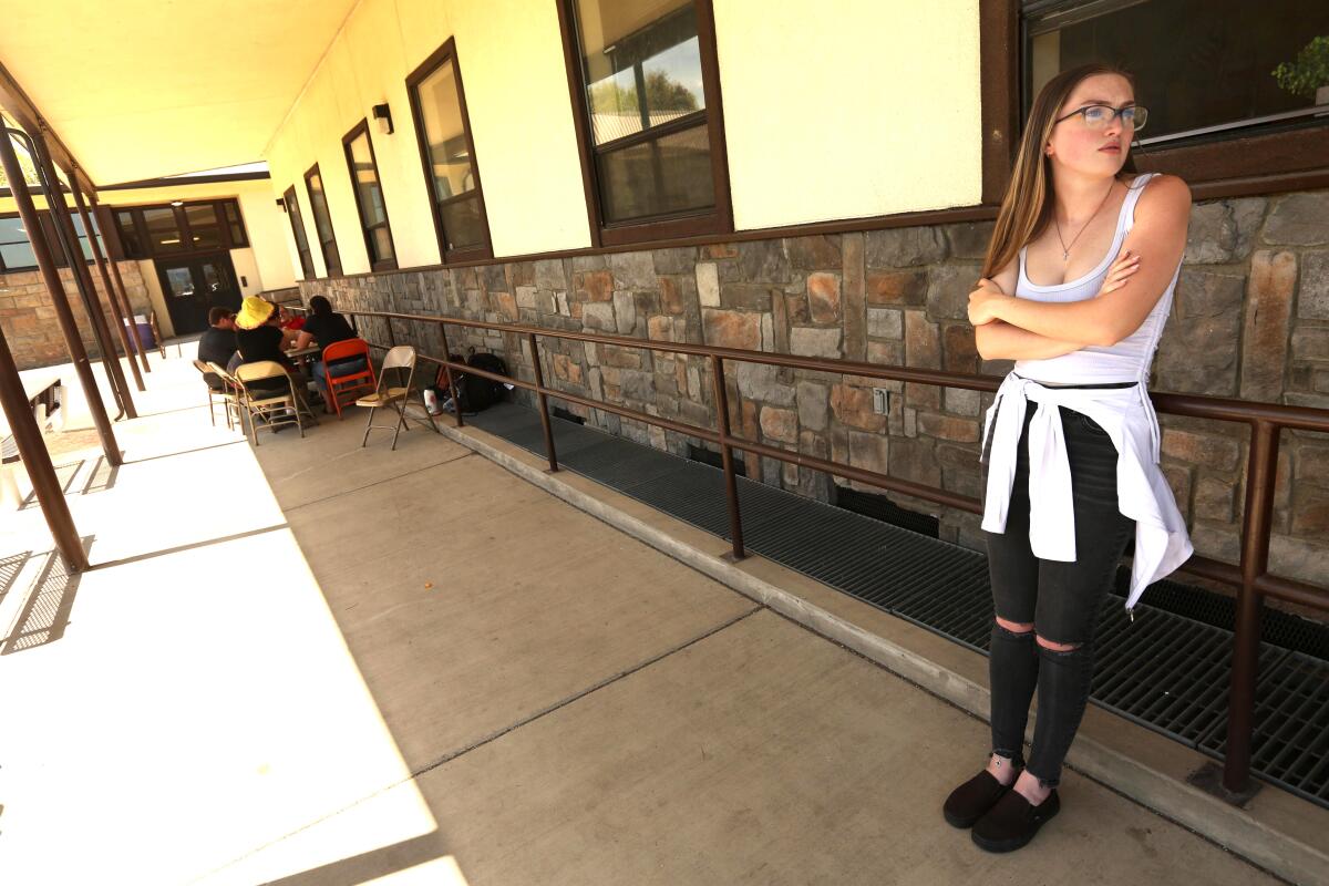 A woman leans against a railing