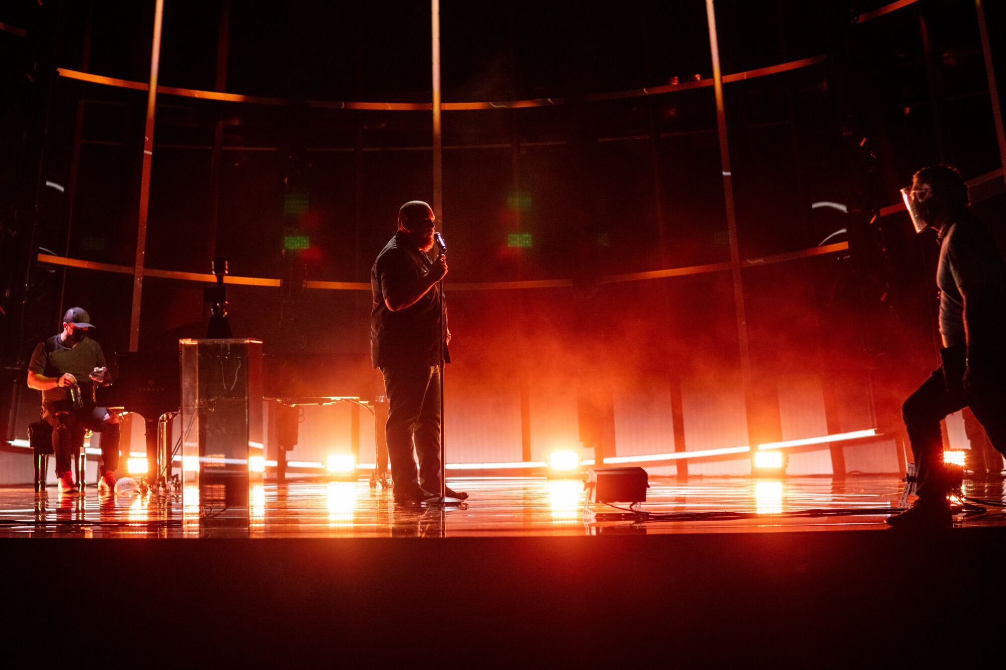 Luke Combs rehearses the day before the 2020 Billboard Music Awards at the Dolby Theatre surrounded by personnel in PPE. 