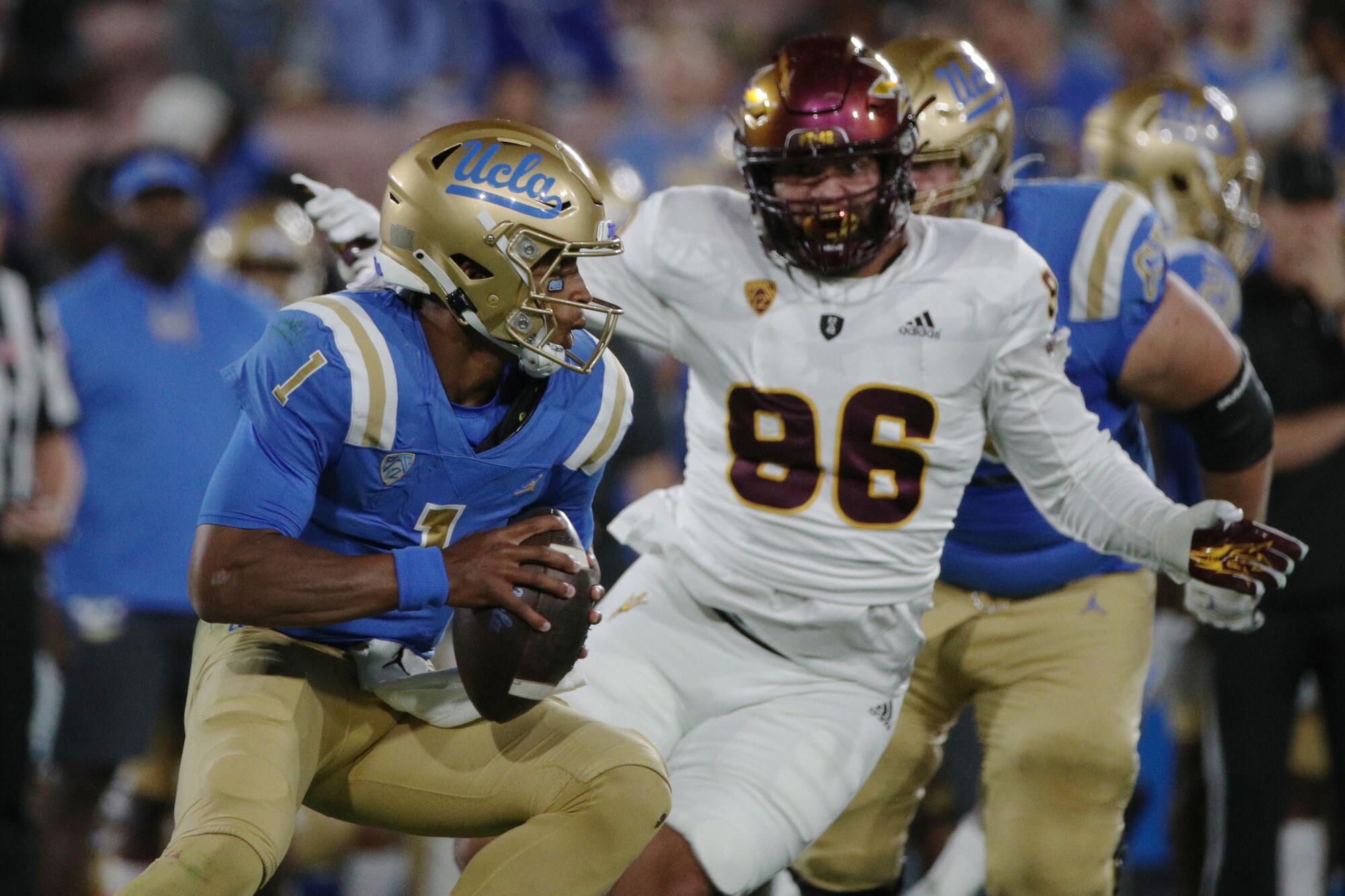 UCLA quarterback Dorian Thompson-Robinson scampers out of the pocket at the Rose Bowl on Saturday.