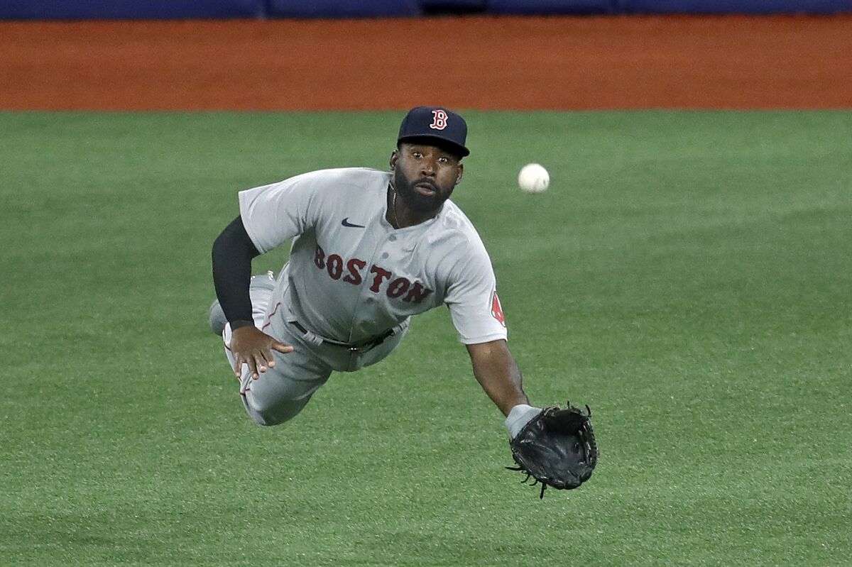 Boston Red Sox center fielder Jackie Bradley Jr. (19) makes a diving catch on a flyout by Tampa Bay Rays' Brandon Lowe during the third inning of a baseball game Tuesday, Aug. 4, 2020, in St. Petersburg, Fla. (AP Photo/Chris O'Meara)
