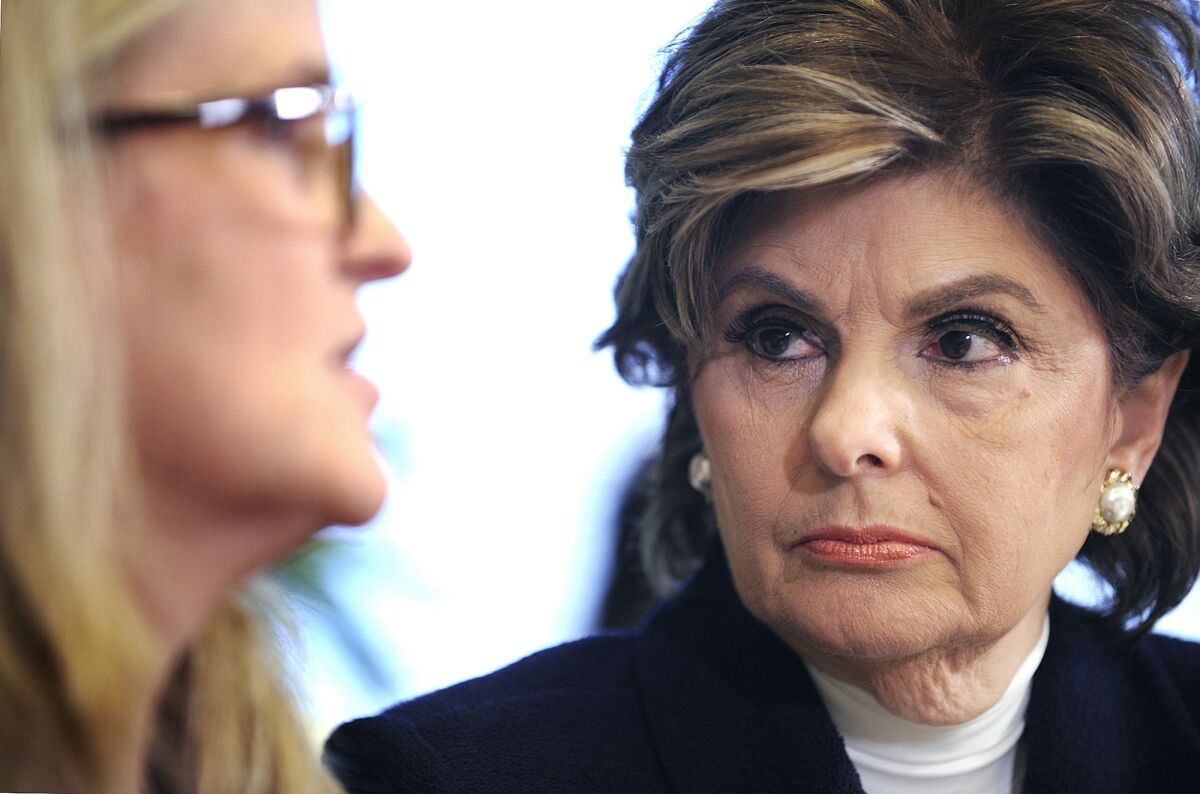 Gloria Allred listens as one of three new women stepping forward to accuse Bill Cosby of sexual assault speaks during a news conference at Allred's office in Los Angeles on Jan. 7, 2014.
