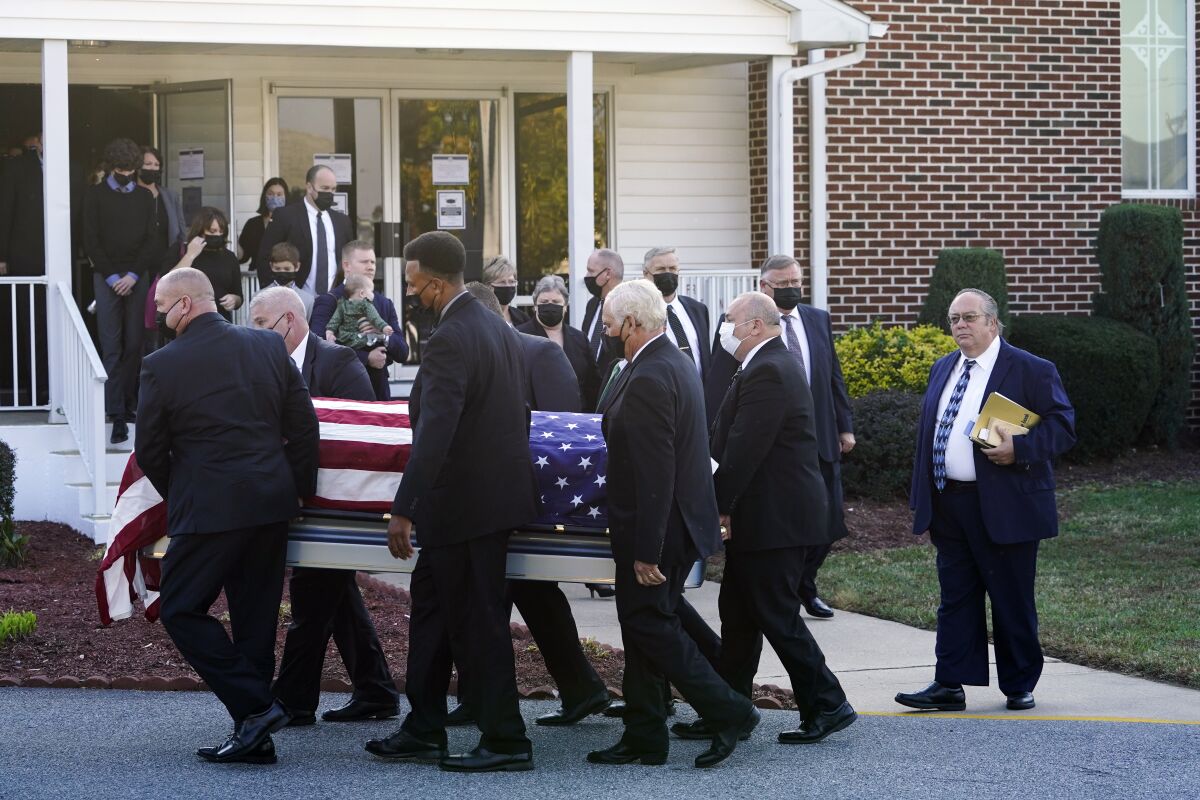 The flag-draped casket of former Delaware Gov. Ruth Ann Minner is carried out of the Church of Nazarene after a funeral service in Milford, Del., Wednesday, Nov. 10, 2021. (AP Photo/Andrew Harnik)
