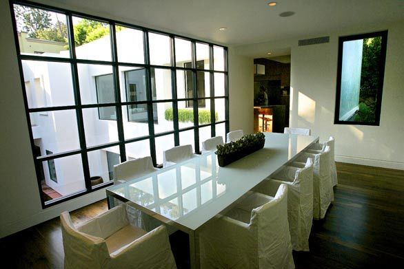 Box-shaped windows cast more patterns of light in the upstairs dining area.