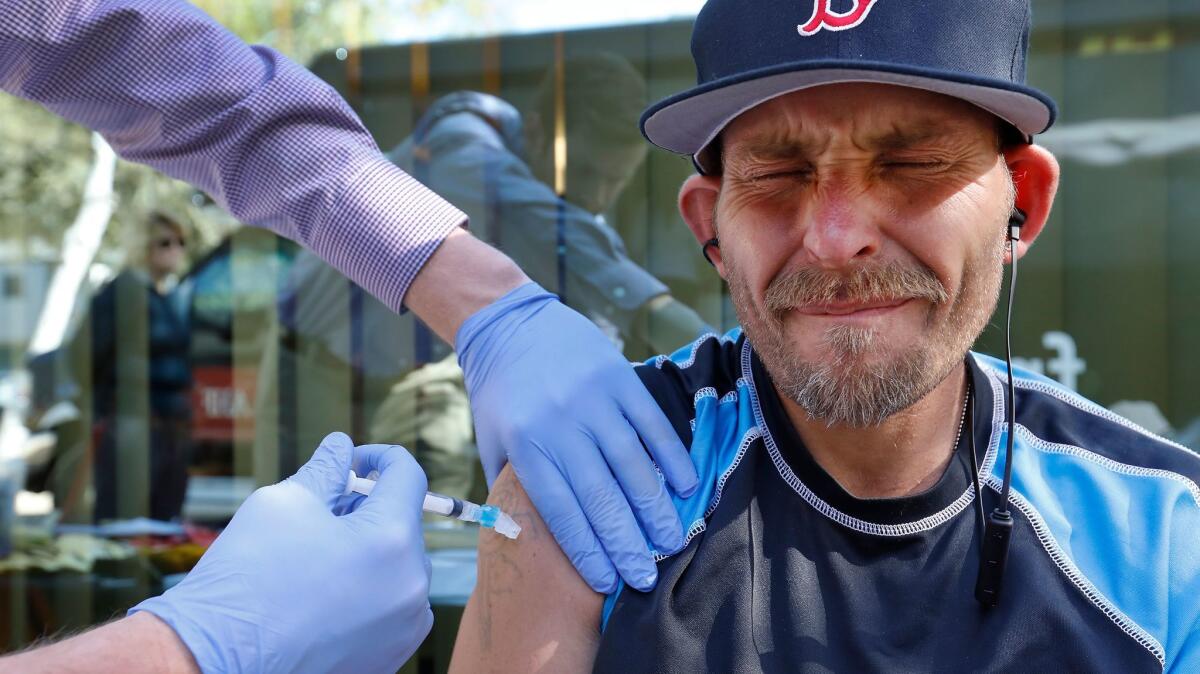 Cory Preston Adams, 38, who is homeless, receives a hepatitis A vaccination in West Hollywood, part of a free mobile clinic aimed at combating the spread of the disease fueled by poor sanitary conditions.