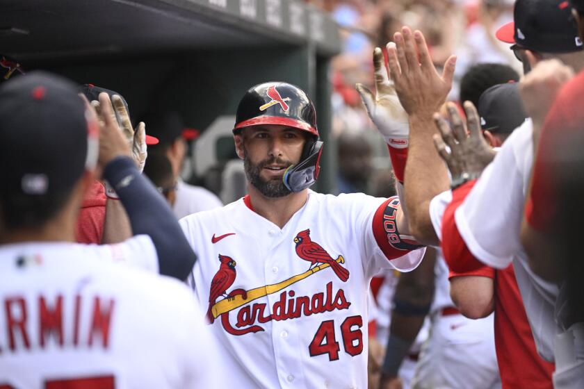St. Louis Cardinals' Paul Goldschmidt (46) is congratulated after hitting a solo home run in the fifth inning of a baseball game against the Philadelphia Phillies on Sunday, Sept. 17, 2023, in St. Louis. (AP Photo/Joe Puetz)