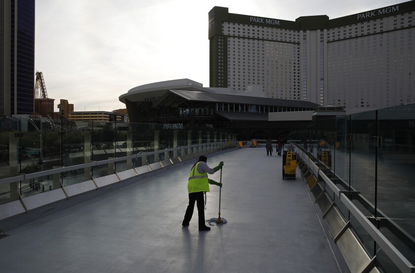 A worker cleans along the Las Vegas Strip devoid of the usual crowds 