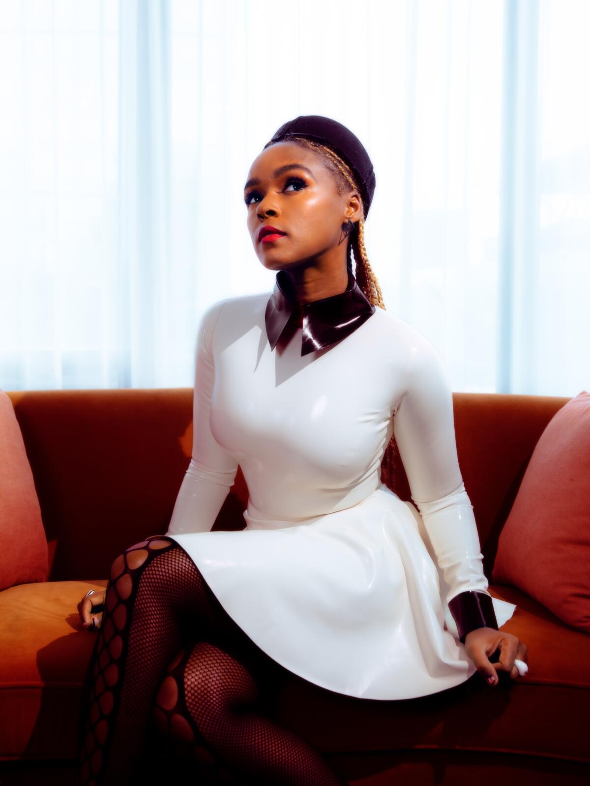 Janelle Monáe poses for a photo in a white dress with a black collar at the Pendry hotel in New York.
