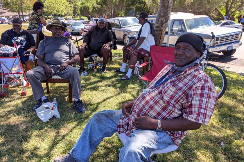 Local men routinely gather to socialize in the parking lot of Marin City's public housing "low rises." Longtime residents like Kurth Bailey, front left, and Andrew Johnson, right, were among the first settlers of Marin City, whose families moved here from the South in the 1940s and ’50s. 