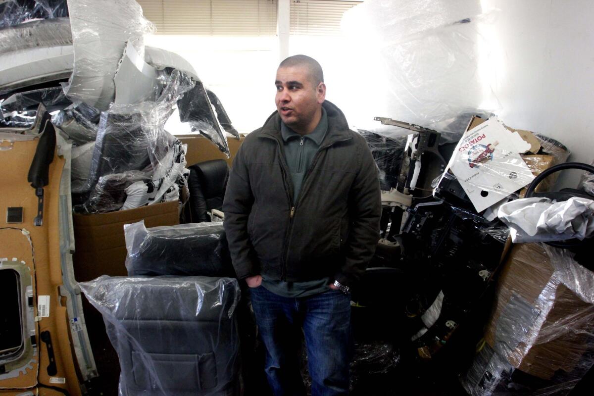 Iraqi immigrant Ubaida Mufrej stands in the office of his car parts export business in Seattle. Mufrej came to the United States under a special visa program for Iraqis who worked with U.S.-led forces during the Iraq War.