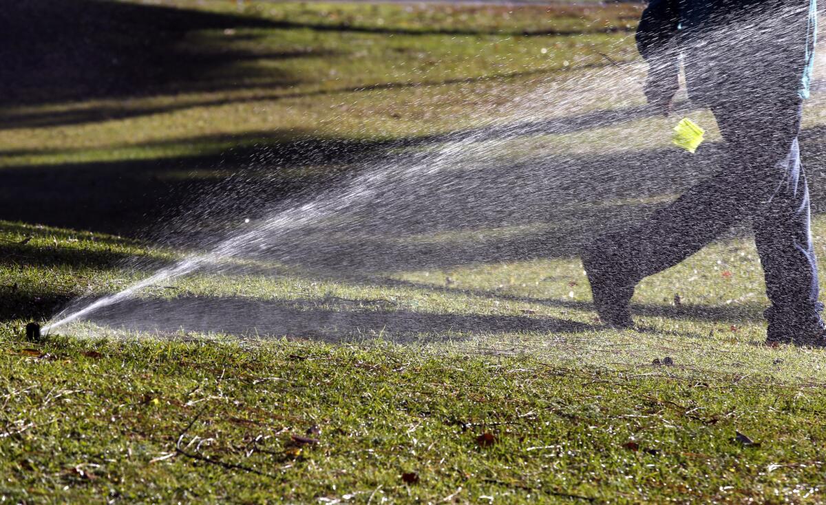 Landscape crews test sprinklers and make drought-conscious adjustments to the flow and spread in Bixby Park and other parks in the city of Long Beach in April.