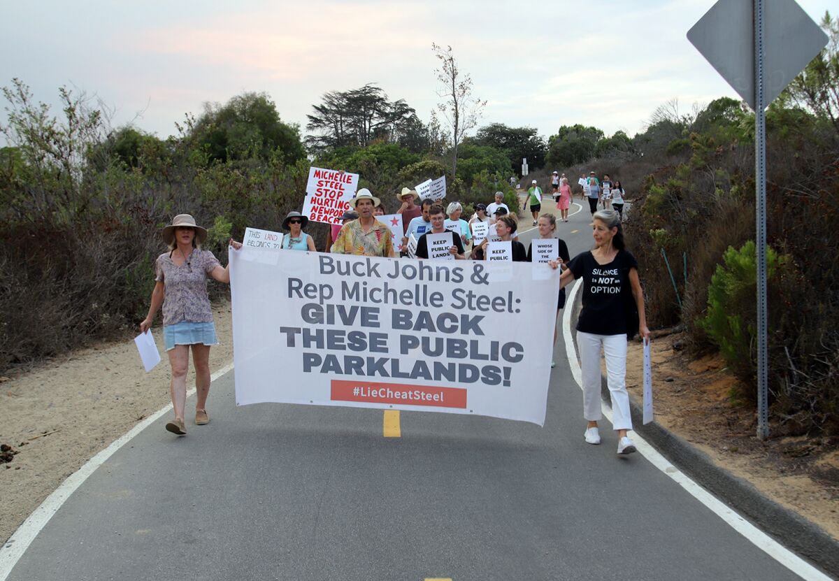 Protesters march to the fence site demonstrating against the proposed and failed sale.