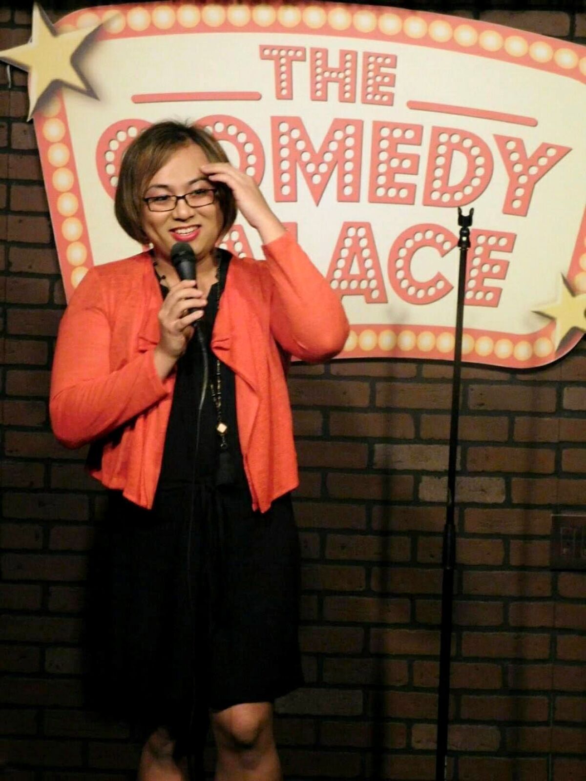 Robin Tran onstage at the Comedy Palace. 