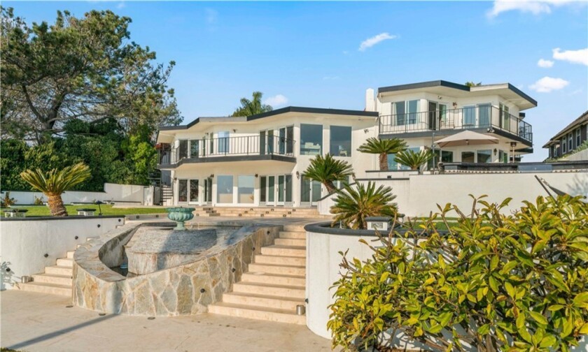 Perched atop a bluff, the Spanish-style home overlooks the ocean from decks, patios, balconies and lawns.