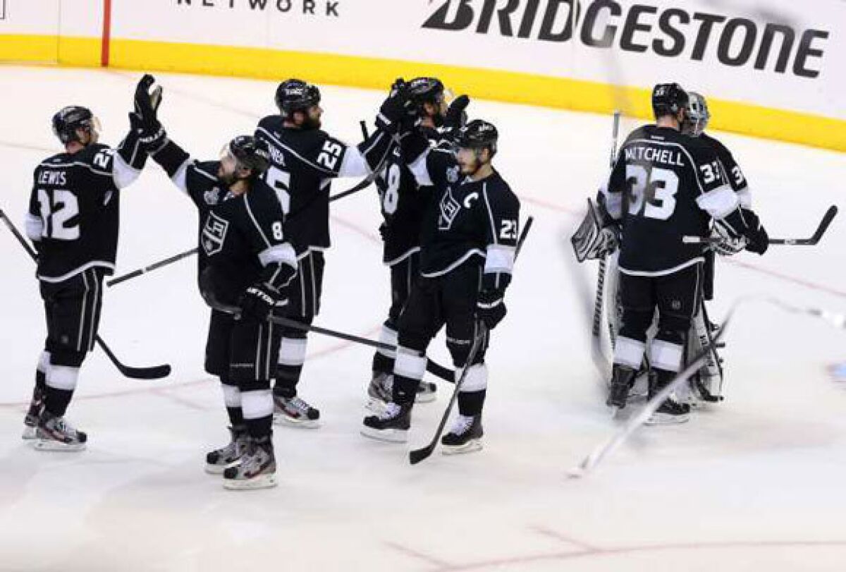 Some of the Kings congratulate each other after defeating New Jersey in Game 3.