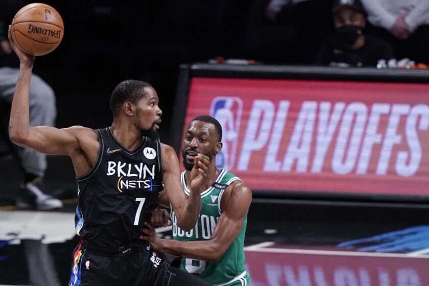 Brooklyn Nets forward Kevin Durant (7) looks to pass the ball as Boston Celtics guard Kemba Walker (8) defends during the first quarter of Game 2 of an NBA basketball first-round playoff series Tuesday, May 25, 2021, in New York. (AP Photo/Kathy Willens)