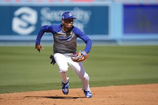 Dodgers shortstop Mookie Betts chases the ball during practice before the team played the Cardinals Friday