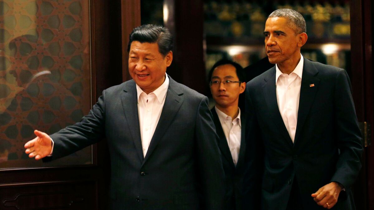 President Barack Obama is shown the way by China's President Xi Jinping as they enter a room for a meeting in Beijing on Nov. 11, 2014.