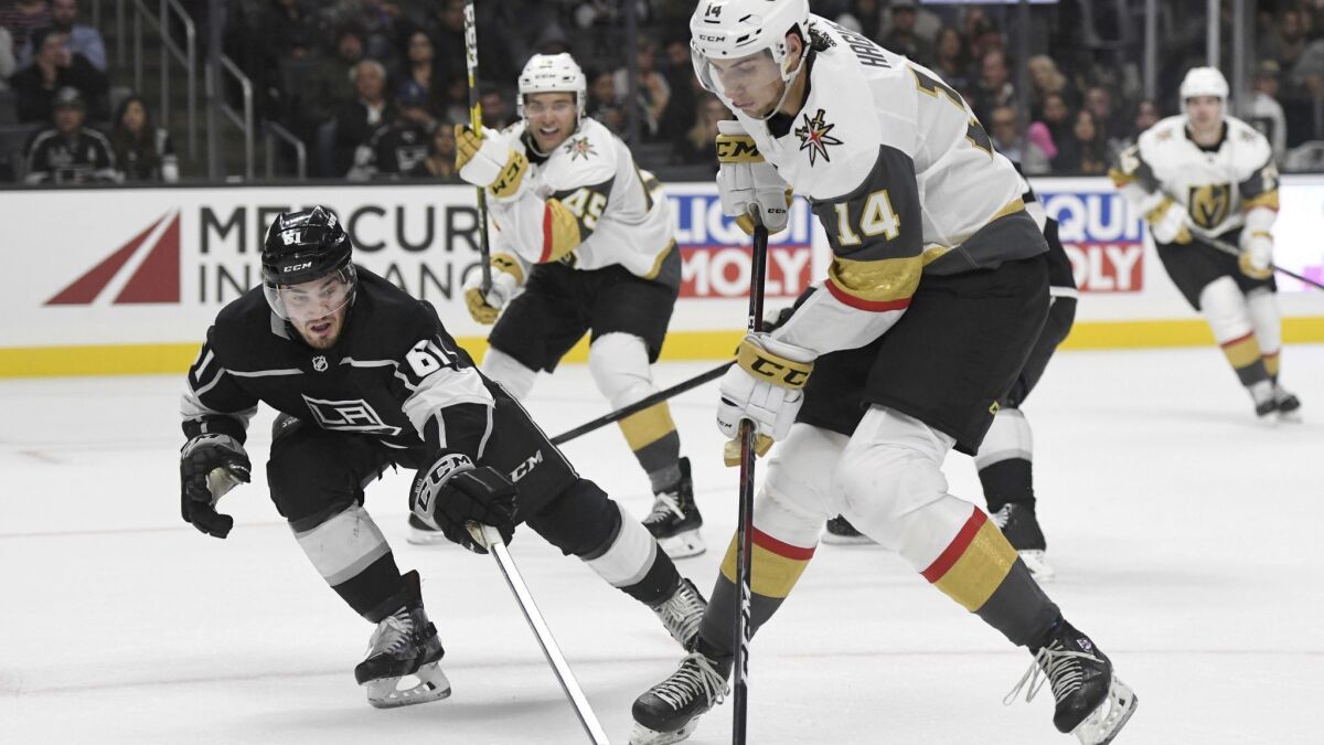 Defenseman Sean Walker, left, challenging Vegas defenseman Nicolas Hague for the puck during an exhibition game in September, is called up by the Kings and winger Jaret Anderson-Dolan is sent to junior team.