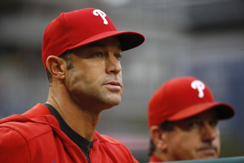 Philadelphia Phillies manager Gabe Kapler stands in the dugout in the third inning of a baseball game against the Washington Nationals, Thursday, Sept. 26, 2019, in Washington. (AP Photo/Patrick Semansky)