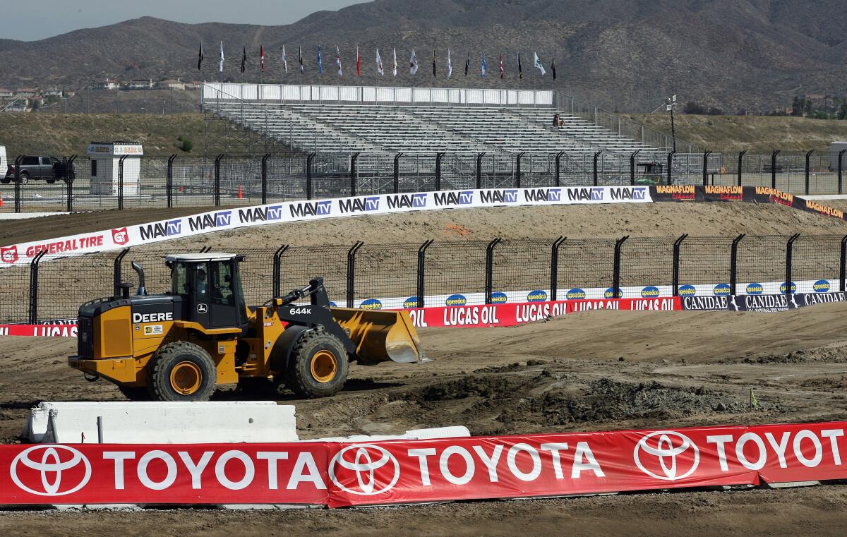 A tractor works on grading a race track in 2012 at Lake Elsinore Motorsports Park.