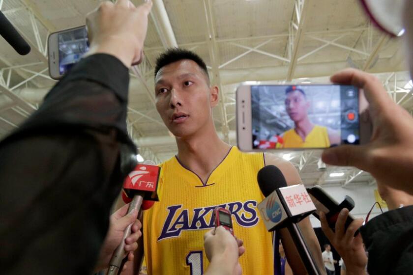 Yi Jianlian speaks to reporters during the Lakers' media day at the team's practice facility in El Segundo on Sept. 26.