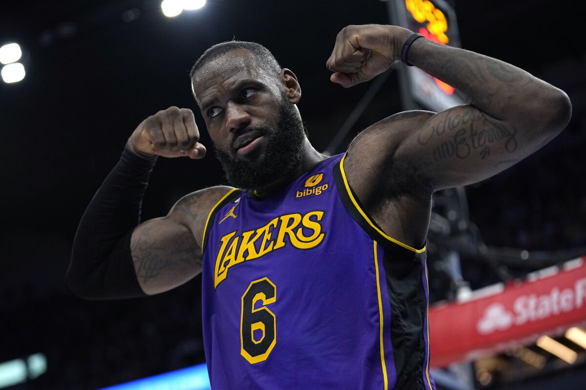 The Lakers' LeBron James flexes after he made a basket while being fouled during the second half  March 31, 2023.