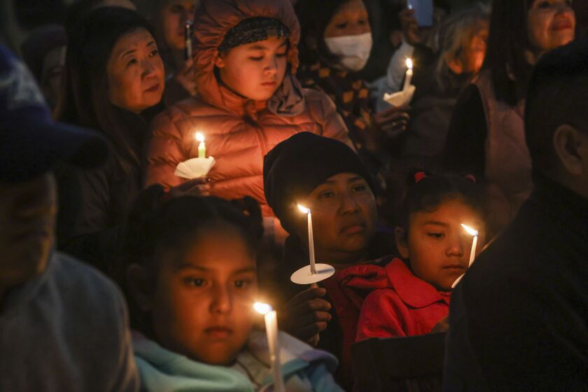 FILE - People gather at a community vigil for the Half Moon Bay shootings earlier in the week in Half Moon Bay, Calif., Friday, Jan. 27, 2023. Workers who witnessed the Jan. 23, 2023, shooting or worked at one of the farms spoke to The Associated Press on Feb. 2, 2023, about what they saw and their working conditions. Authorities say Chunli Zhao shot and killed seven people and injured an eighth at two mushroom farms where he had worked. (Gabrielle Lurie/San Francisco Chronicle via AP, File)