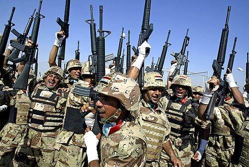 Iraqi soldiers celebrate during a ceremony marking the transfer of security control in Karbala province from the U.S. to Iraq. Karbala is the eighth of Iraq's 18 provinces to resume responsibility for its own security. The move had been delayed several times because of violence.