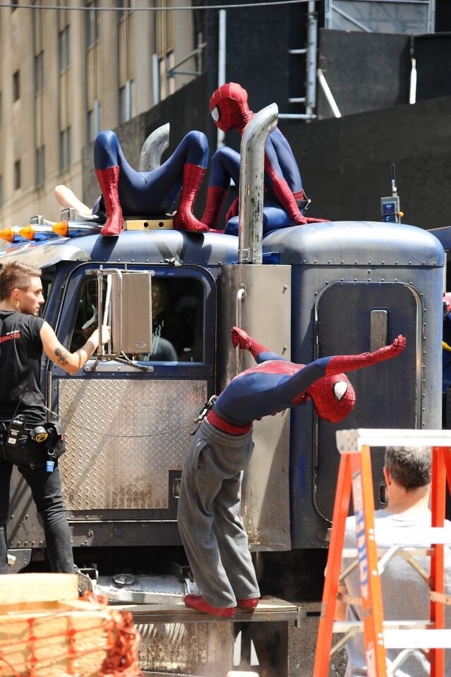 Actor Andrew Garfield, right, his stunt double William Spencer, center, and a second stunt double are seen on the set of "The Amazing Spider-Man 2" in New York City.