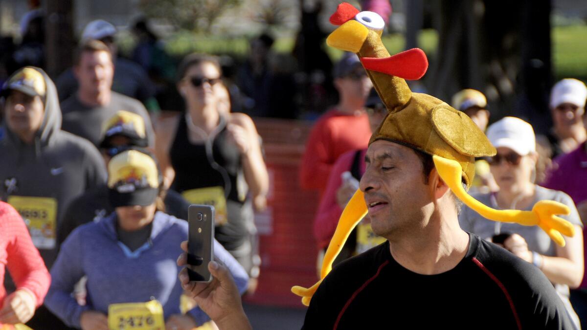 A man wearing a turkey headdress runs in a race in 2016.