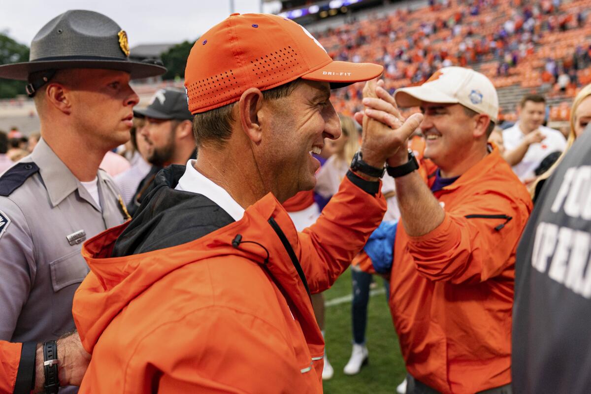 Clemson Tigers head coach Dabo Swinney celebrates after defeating the Furman Paladins during an NCAA college football game in Clemson, S.C., Saturday, Sept. 10, 2022. (AP Photo/Jacob Kupferman)