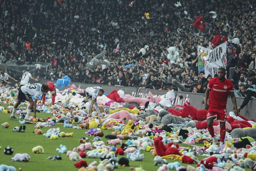 Fans throw toys onto the pitch during thesoccer match between Besiktas and Antalyaspor at the Vodafone stadium in Istanbul