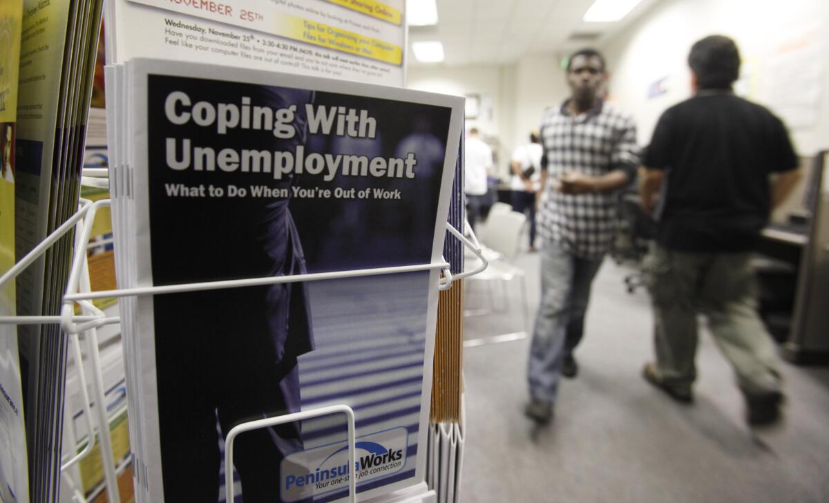 People arrive to seek job opportunities at an employment office in Menlo Park, Calif.