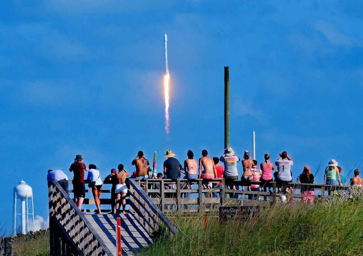 Crowds pack the Canaveral National Seashore on May 27 to witness the liftoff of a SpaceX Falcon 9 rocket with the THAICOM-8 satellite aboard.