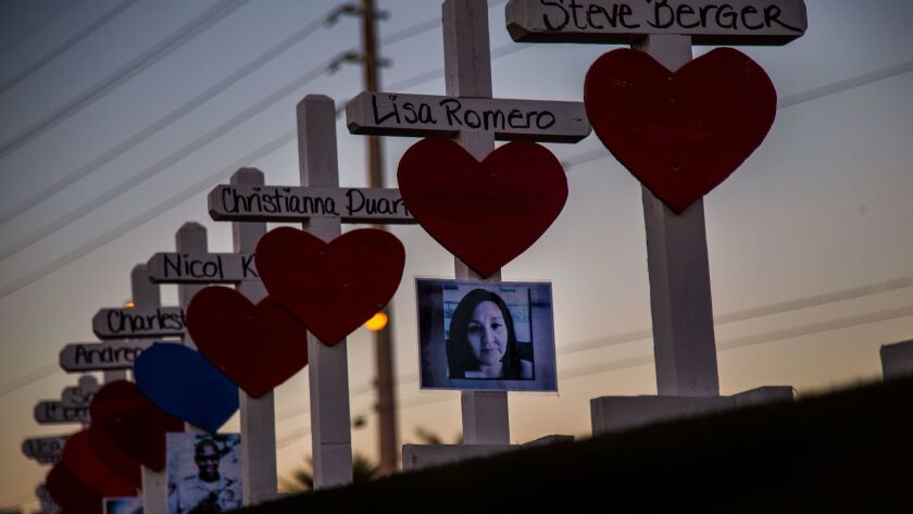 Wooden crosses bearing the names of those killed in the mass shooting line the median near the Welcome to Las Vegas sign off Las Vegas Boulevard.