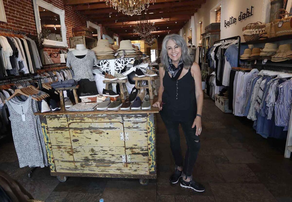 Deanna Frieze is happy to open her doors at Sunny Days in Laguna Beach on Friday.