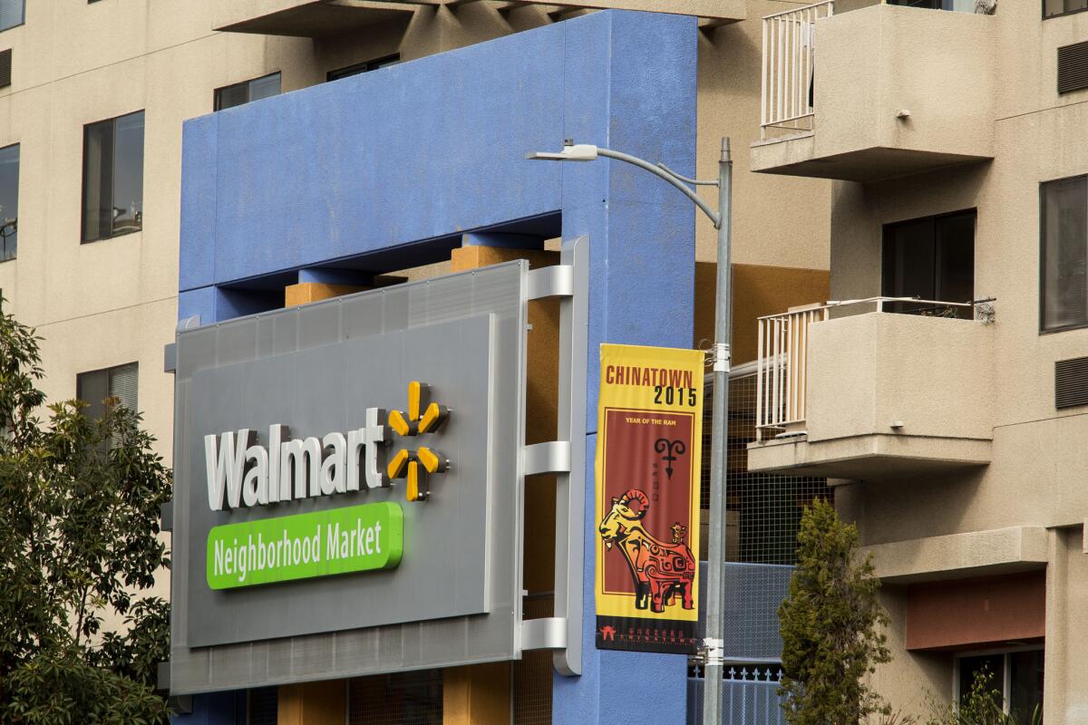 Wal-Mart reported disappointing results and cut its sales projections on Thursday. Shown is the chain's now-closed store in Los Angeles' Chinatown.
