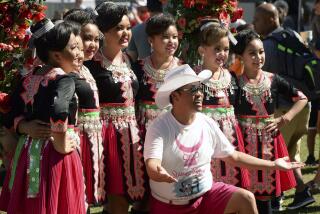 Founder and organizer Tou Ger Xiong, front, poses with a group of Hmong dancers during Hmong Minnesota Day at the Minnesota State Fair, Sept. 6, 2021, in Falcon Heights, Minn. On Wednesday, Dec. 13, 2023, Colombian authorities were investigating the alleged kidnapping and murder of the Hmong American comedian and activist Xiong, who was found dead Monday, Dec. 11, in a wooded area of the northern city Medellín. (Scott Takushi/Pioneer Press via AP)