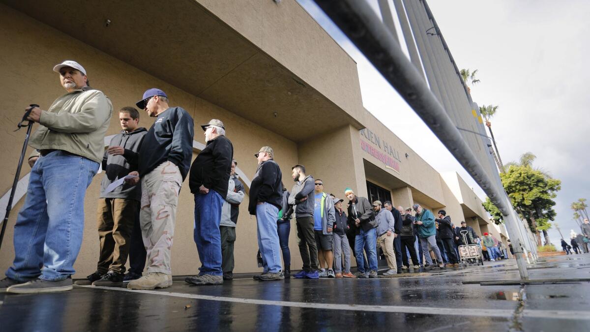 People line up to enter a Crossroads West Gun Show in 2018 at the Del Mar Fairgrounds.