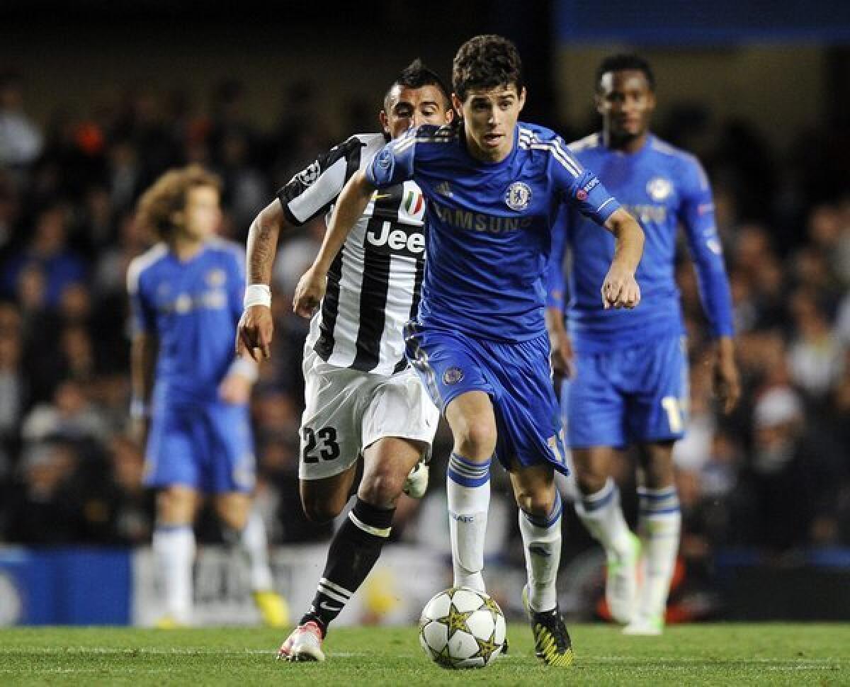 Chelsea's Oscar moves the ball ahead of Arturo Vidal of Juventus.