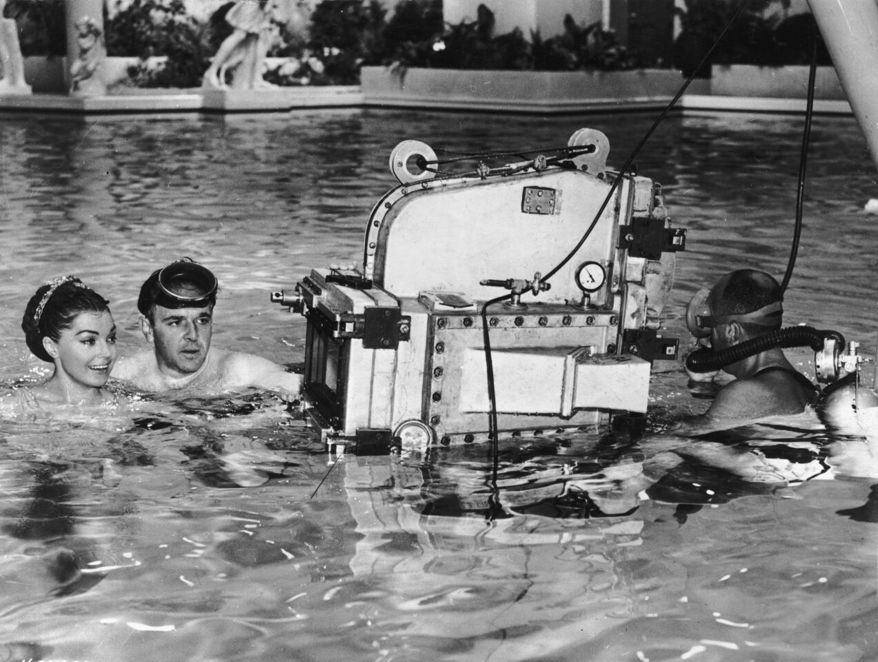 1955: Director George Sidney, left, wears a diving mask while directing American swimmer and actress Esther Williams on the set of his film "Jupiter's Darling." The cameraman is wearing scuba gear.