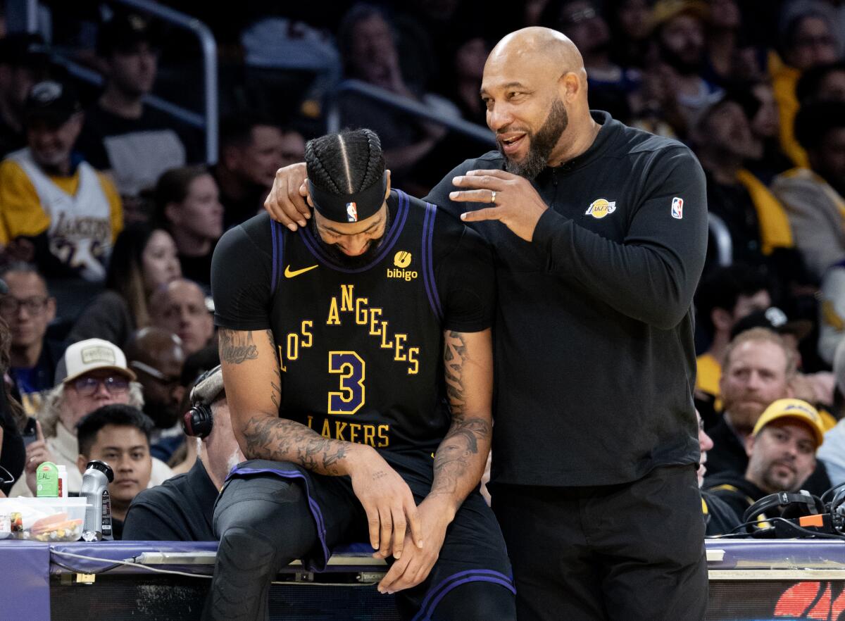 Lakers forward Anthony Davis and coach Darvin Ham share a laugh during the team's blowout win over the Utah Jazz