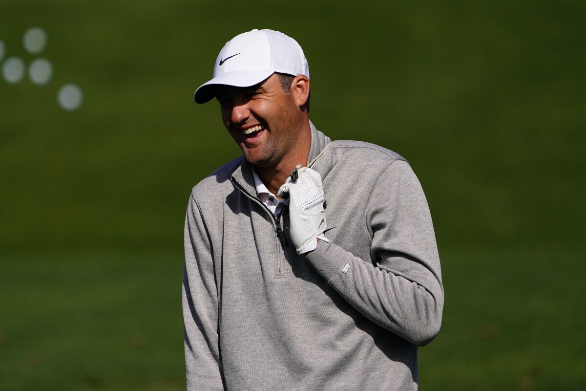 Scottie Scheffler laughs while on the driving range during a practice round for the Masters golf tournament on Monday, April 4, 2022, in Augusta, Ga. (AP Photo/Matt Slocum)