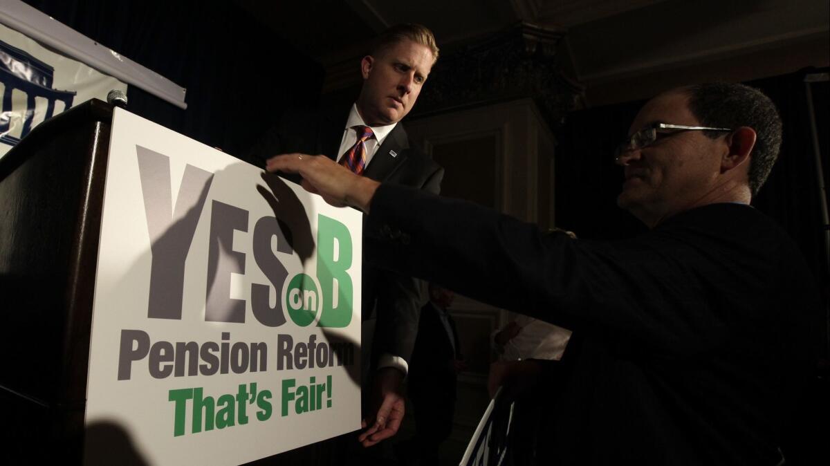 Supporters of Proposition B, which made San Diego the only California city to discontinue traditional pensions for new hires, adjust a sign before a rally. The measure was approved by 65% of city voters in June 2012.