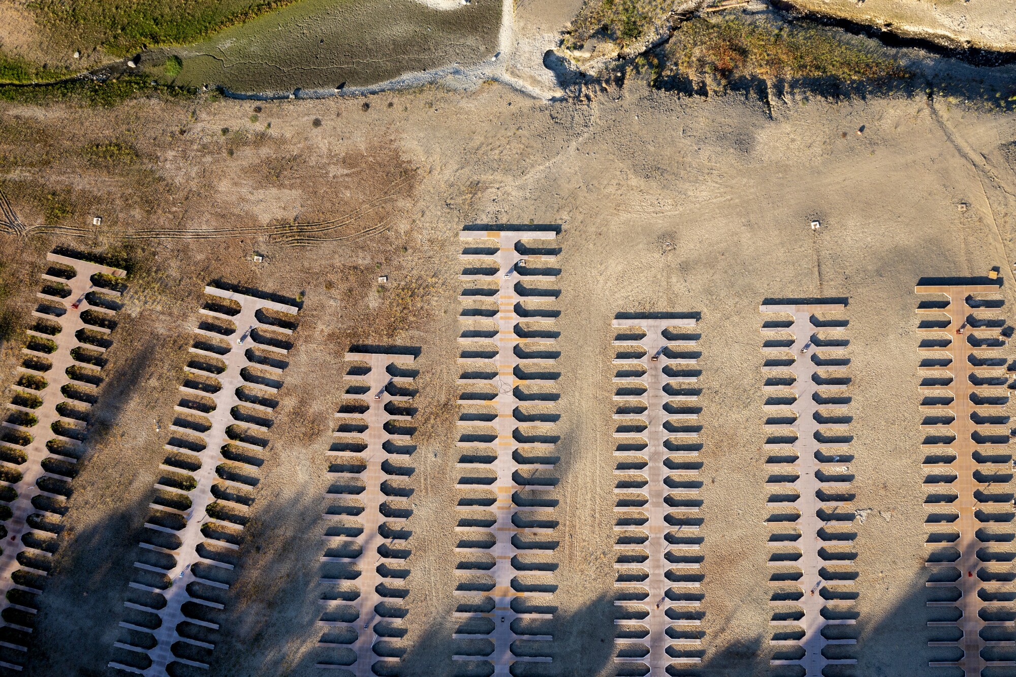 Boat slips and dry dirt are seen in an aerial view.