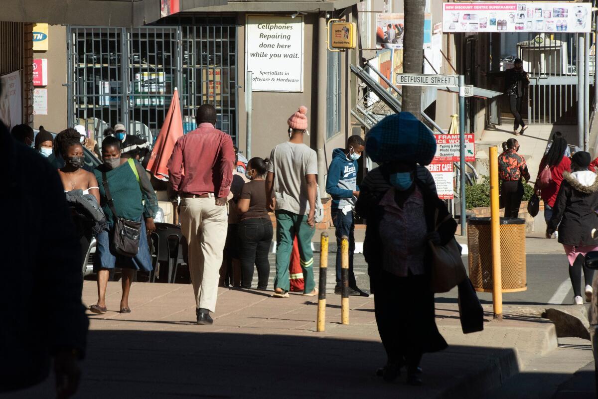 People walk through the city streets of Mbabane on July 3, 2021.