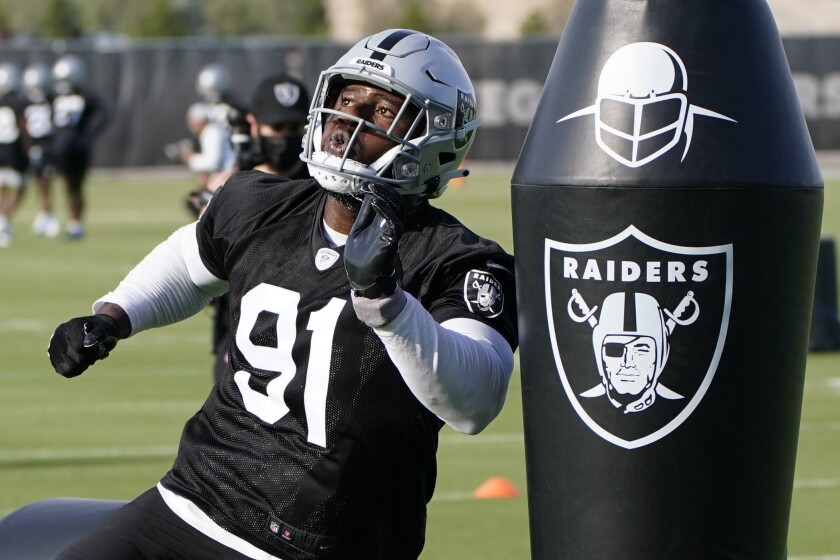 Las Vegas Raiders defensive end Yannick Ngakoue takes part in a drill during an NFL football practice Tuesday, June 15, 2021, in Henderson, Nev. (AP Photo/John Locher)