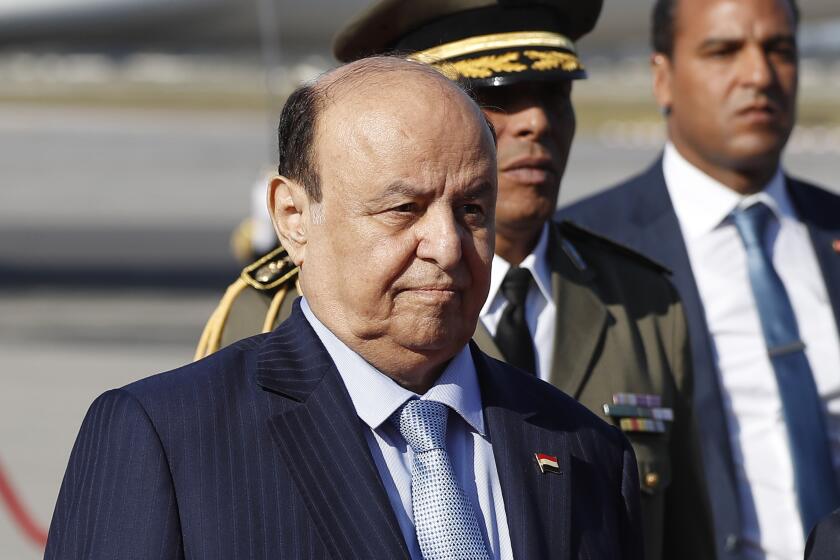 FILE - Yemen's President Abed Rabbo Mansour Hadi walks next of his Tunisian counterpart Beji Caid Essebsi, not in photo, upon his arrival at Tunis-Carthage international airport to attend the Arab Summit, in Tunis, Tunisia, March 30, 2019. Yemen’s exiled president stepped aside and transferred his powers to a presidential council on Thursday, April 7, 2022, as international and regional efforts to end the country’s long-running civil war gained momentum with a two-month truce.(AP Photo/Hussein Malla, File)