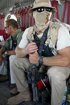 U.S. private security officers are shown in 2003 in a Chinook helicopter that was guarding L. Paul Bremer, Iraq's U.S. civilian administrator at the time, as he ventured near the city of Basra. Tens of thousands of such employees operate in the war-torn country. Today, the Interior Ministry canceled the license of the American security firm Blackwater USA after officials charged that eight civilians were shot and killed Sunday by company bodyguards accompanying a U.S. State Department motorcade. American officials are launching an investigation in conjunction with Iraq, a spokeswoman said.