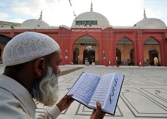 A Pakistani Muslim reads the Koran outside a mosque in Karachi, Pakistan, on the first day of the Muslim fasting month of Ramadan. Ramadan is Islam's most sacred month, during which devout Muslims observe a dawn-to-dusk fast and attend special evening Taraweeh congregations, during which the Koran is recited. During the month, eating, drinking, sex and smoking in public places is banned and restaurants are forbidden to serve food during the fasting hours.